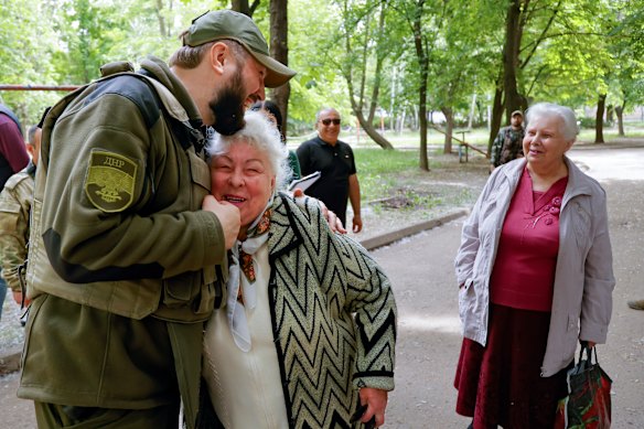 A serviceman of Donetsk People’s Republic militia embraces a local woman in Svitlodarsk, in territory under the government of the Russia-backed Donetsk People’s Republic, in eastern Ukraine,