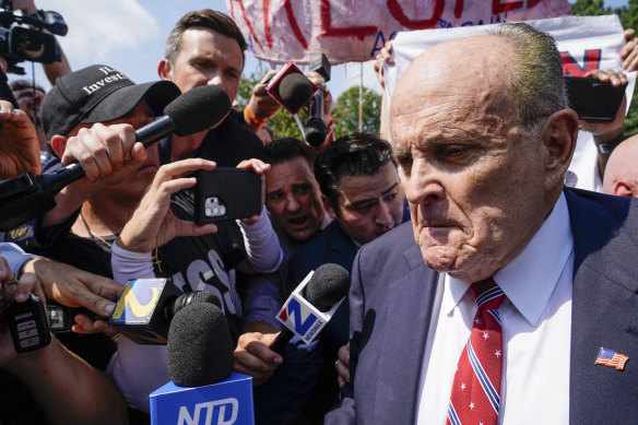 Rudy Giuliani speaks outside the Fulton County jail in Atlanta before being charged in relation to Trump’s attempt to overturn the 2020 election results.