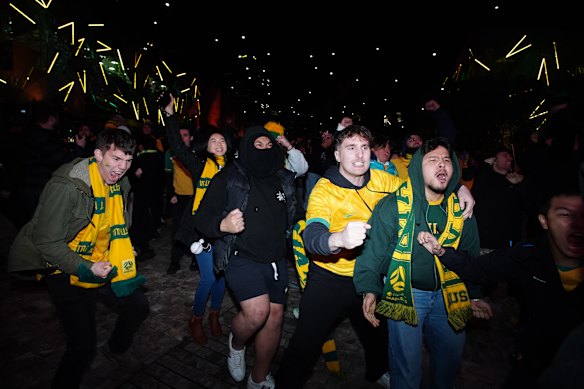 Socceroos fans celebrate the goal.