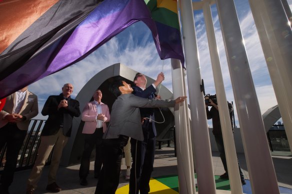 Premier Daniel Andrews and Victorian Pride Centre chair Hang Vo raise the flag at the centre in St Kilda on Sunday.