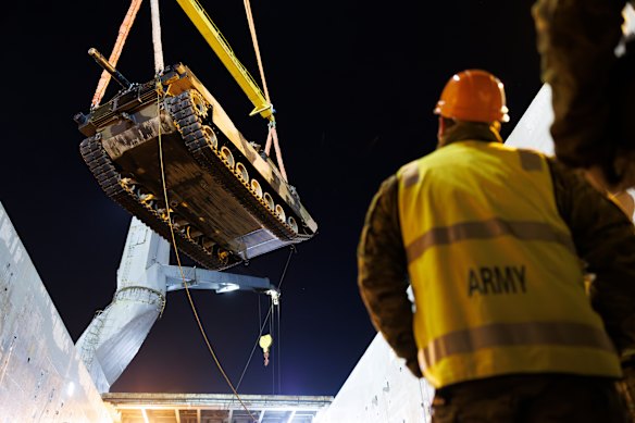 An Australian Army M1A1 Abrams main battle tank is lifted onto a ship in Australia, bound for Ukraine. 