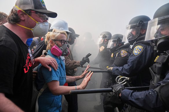 Protesters confront police near the metropolitan detention centre of downtown Los Angeles on Sunday.
