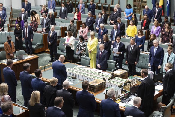 The members of the House of Representatives stand for a minute’s silence for the condolence motion for Captain Danniel Lyon, Lieutenant Maxwell Nugent, Warrant Officer Class 2 Joseph Phillip Laycock and Corporal Alexander Naggs.