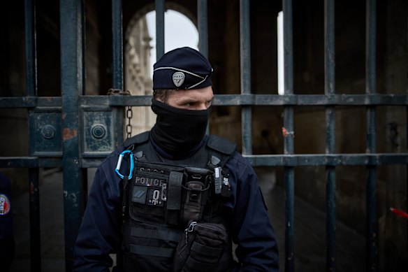 French Police officers seal off the entrance to the Louvre following the heist.
