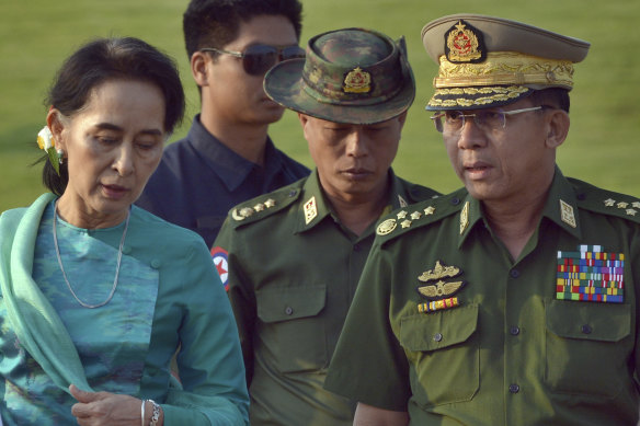 Aung San Suu Kyi with Min Aung Hlaing, right, before the coup. She has been detained since February 2021 on 17 charges brought against her by the junta that could see her sentenced to more than 100 years in prison.