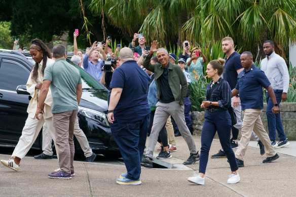 Barack Obama waves to onlookers after leaving Bathers’ Pavilion restaurant in Balmoral on Monday.