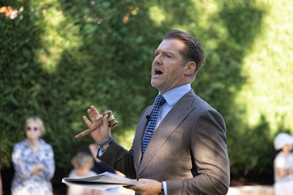 Auctioneer Peter Kakos competed with carolling magpies on Saturday at Cremorne Point to entice bidders assembled in the garden of 24 Hodgson Avenue. 