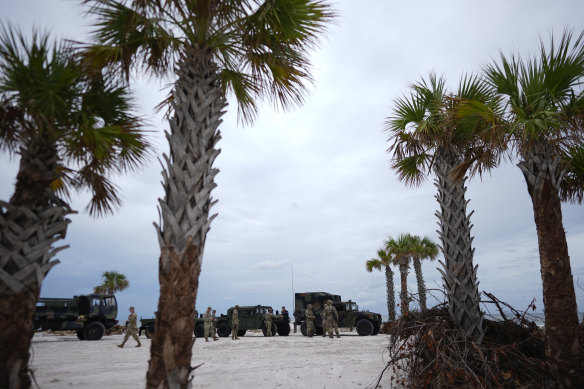 Members of the Florida Army National Guard stage on a beach as they prepare for the arrival of Hurricane Milton, in Bradenton Beach, Florida.