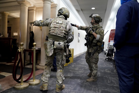 Members of the Federal Bureau of Investigation swat team patrol the halls after the capitol Hill riots. 