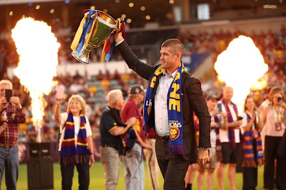 Triple-premiership former Lion Jonathan Brown walked out with the 2025 premiership cup during the flag unfurling ceremony.