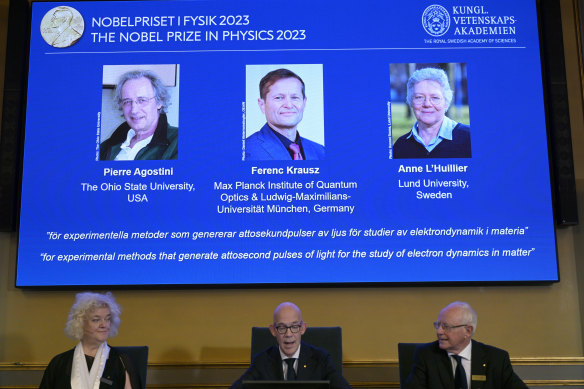 The permanent secretary of Sweden’s Royal Academy of Sciences, Hans Ellegren (centre), and members Mats Larsson (left) and Eva Olsson, announce the winners of the 2023 Nobel Prize in Physics.