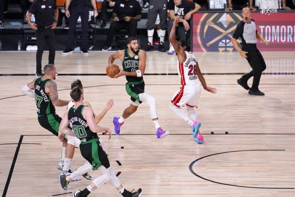 Boston's Jayson Tatum drives against Miami Heat's Andre Iguodala in their eastern conference final play-off clash.