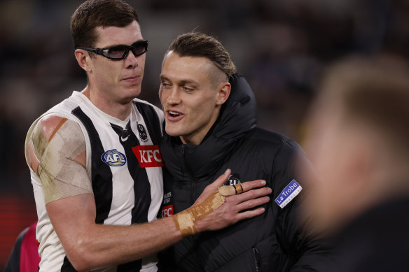 Mason Cox with Darcy Moore, who was subbed out of the match with concussion.