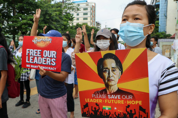 Anti-coup protesters march along a street in Yangon, Myanmar.