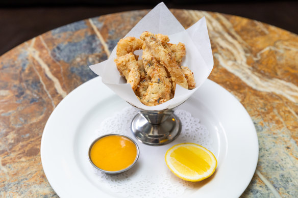 Deep-fried tripe served in a seafood cocktail dish with lemon and rouille for dipping. 