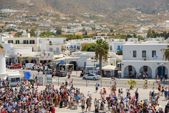 Tourists wait to board the ferry on Paros.