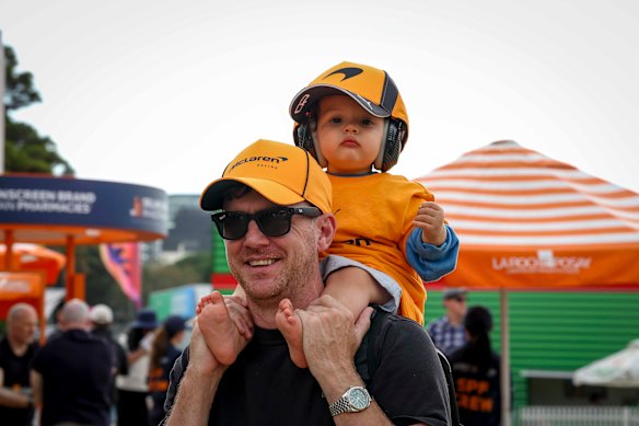 Start ’em young: A tiny fan with ear protection is ready to enjoy the action.