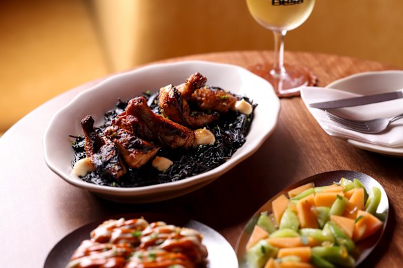 Grilled chicken and noodles dressed in squid ink.