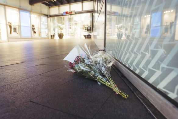 Flowers are left at the scene on Sunday morning.