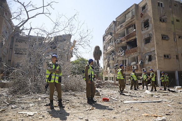 Emergency workers at the site of Iranian missile strike in Holon, Israel.