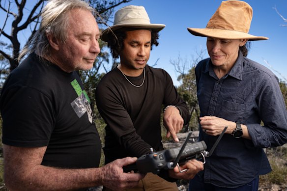 Drone archaeologist Dr Jacob Bongers (centre) with research archaeologist Dr Amy Mosig Way (right) and Gomeroi man, archaeologist and rock art expert  Wayne Brennan. The University of Sydney team is using drones to survey very rugged and remote landscape.