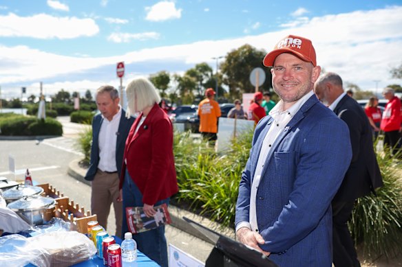 One Nation candidate Luke Herdegen at the polling booths on Saturday, with WA Premier Roger Cook and Labor candidate Georgia Tree in the background.