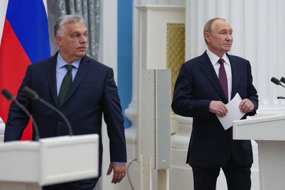 Russian President Vladimir Putin, right, and Hungarian Prime Minister Viktor Orban arrive to make press statements after their talks in the Kremlin in Moscow.