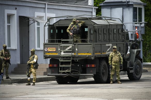 Russian soldiers guard an area as a group of foreign journalists visit in Kherson, Kherson region, south Ukraine.