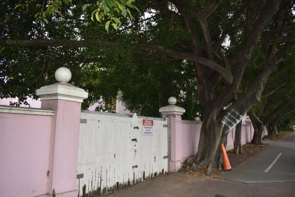A sign on the front fence warning trespassers.