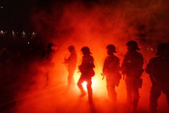 Police in Swan Street, Richmond as A-League fans set off flares before the final on Saturday.