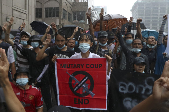 Anti-coup protesters in the rain in Pabedan, Myanmar, on Friday. People continue to demonstrate against the military coup despite a bloody crackdown claiming hundreds of lives.