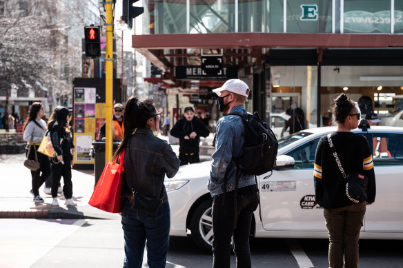 Pedestrians in Wellington, New Zealand, where two people tested positive for COVID-19 on Thursday.