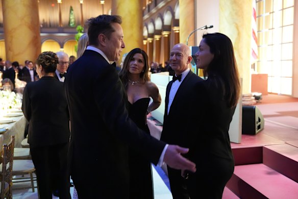 Elon Musk and Shivon Zilis, mother of four of his children, talking with the Amazon founder Jeff Bezos and his fiancee, Lauren Sanchez, at a presidential inauguration party in January. 