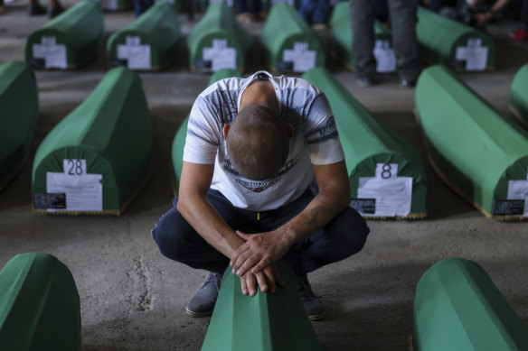 A man mourns next to the coffin of his relative, a victim of the 1995 Srebrenica genocide, in Potocari, Bosnia on Sunday.