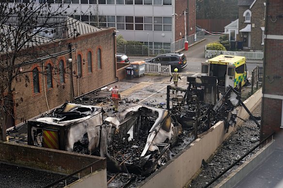 Burnt ambulances in a car park in London.