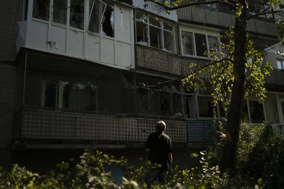 Oleksandr Maiorov, a retired psychiatrist, looks at the damaged residential building after a Russian attack in Sloviansk, eastern Ukraine.