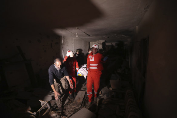 Red Cross volunteers carry one the two bodies of an elderly couple who died when their house was hit by Israeli shelling in the southern town of Chebaa, Lebanon, on Saturday.