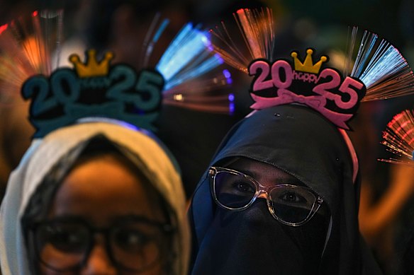 Revellers gather near the Petronas Twin Towers to watch the fireworks for the New Year’s celebrations in Kuala Lumpur, Malaysia.