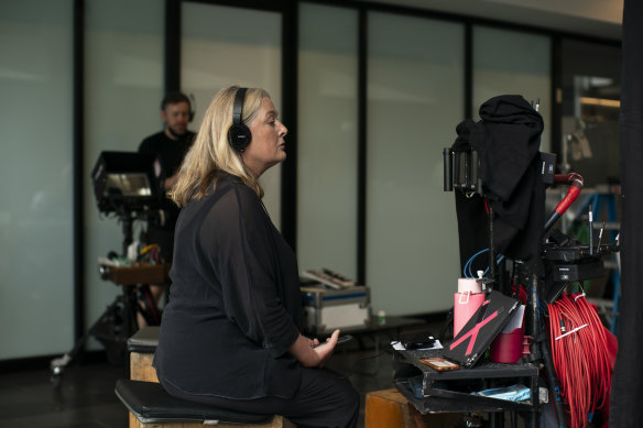 Stephanie Wood on set, watching a monitor as her story plays out on screen.