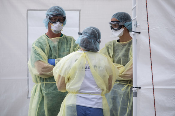 Medical workers near Milar in Italy prepare to treat more patients. 