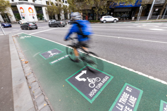 A cyclist rides along Exhibition Street.