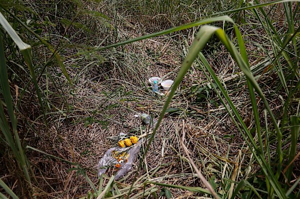 Flowers and bowls of food left by mourners where the body of Tunchanok Donhomla was found inside a suitcase.