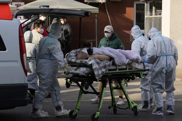 An elderly man is taken into the fever clinic at a hospital in Beijing on Friday.