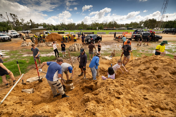 A small army of people fill sandbags at Rochester Recreation Reserve.