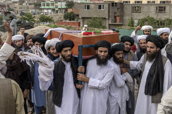Mourners carry the body of a victim of a mosque bombing in Kabul, Afghanistan, on Thursday.