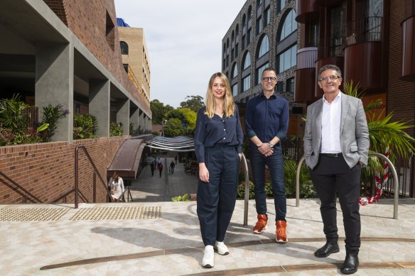 SJB architects Emily Wombwell and Adam Haddow (centre) with developer Allan Vidor at the reopened Surry Hills shopping centre.