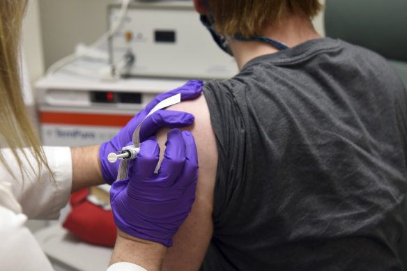 A patient enrolled in Pfizer's COVID-19 coronavirus vaccine clinical trial receives an injection. 