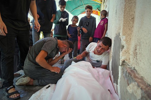 Relatives mourn outside the hospital.