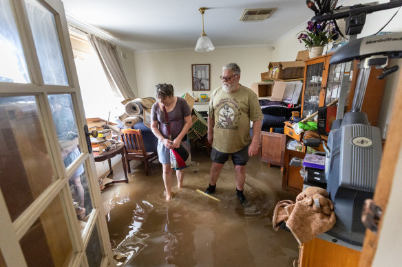 Mooroopna locals Shelly Perry and Bill Weston return to their home for the first time since it was inundated.  