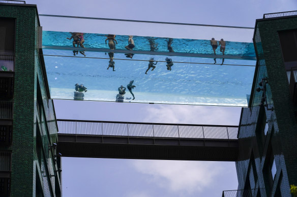 People swim in the elevated pool, called Sky Pool, in London on Monday.